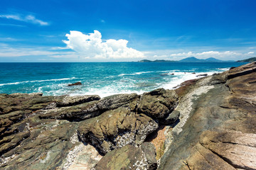 beach with rocks and blue sky