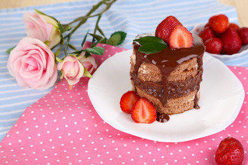 Chocolate cake with strawberry on table close-up
