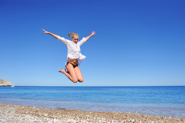 Beautiful Girl Jumping on The Beach