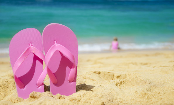 Girl's Flip flops on sandy beach