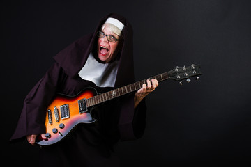 Happy nun playing guitar