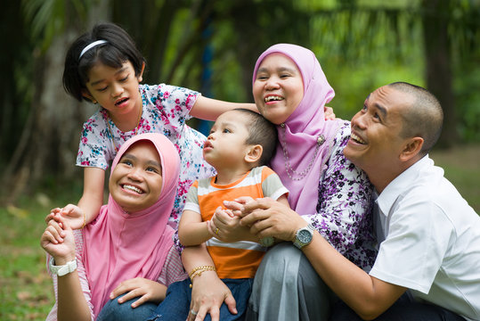lifestyle photo of malay family having fun in the park ,malaysia