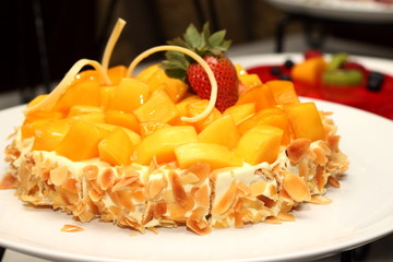Mango cake decorated with almonds trawberry