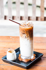 Iced coffee latte with espresso shot in white jar