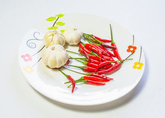 garlic and pepper in dish isolated
