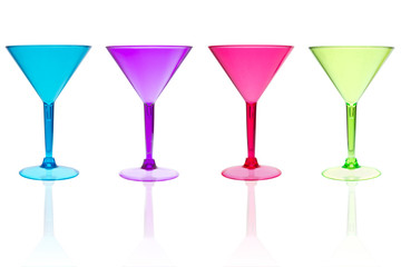 4 different color martini glasses on white