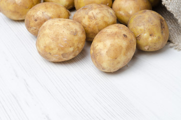 close-up of new potatoes in a sack on a white background