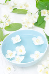 jasmine flowers in a bowl for the spa and aromatherapy, vertical