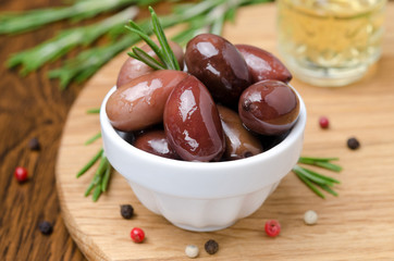 kalamata olives and spices on a wooden board