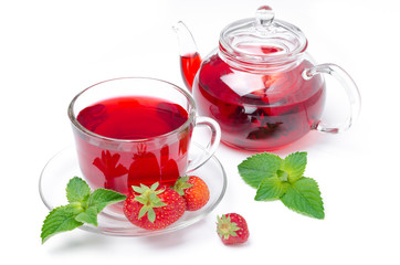 kettle and a cup of red tea with strawberries and mint isolated