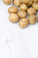 new potatoes in a sack on a white background