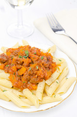 penne pasta with sauce of beef, tomato, pumpkin on a plate