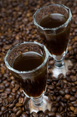 two shot glasses of coffee liqueur, selective focus, close-up