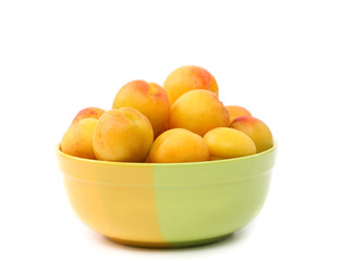 Naklejka na ściany i meble Fresh apricots in cup isolated on white