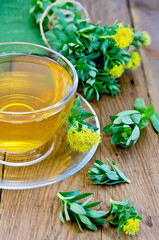 Herbal tea with Rhodiola rosea in the cup on the board