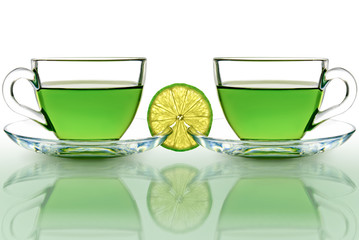 Two cups of green tea with lemon on a white background.