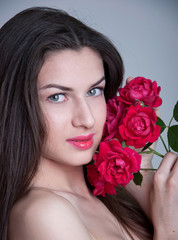 Young woman with red roses