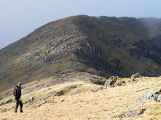 Fototapeta na wymiar A hiker looking up the Pillar, in the Lake District