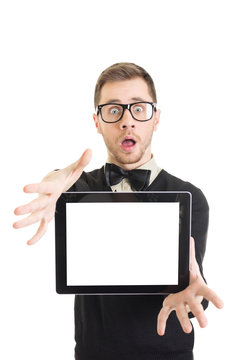 Shocked young nerd man showing blank tablet screen
