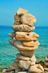 balanced stones on the beach in the summer