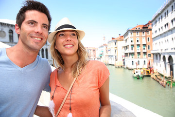 Fototapeta na wymiar Couple of tourists on the Rialto bridge, Venice