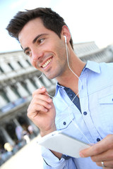Smiling handsome guy talking on the phone with handsfree
