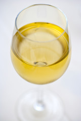 glass of chardonnay wine on white background