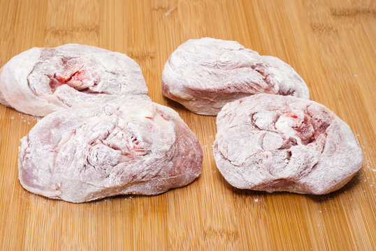 ossobuco floury on wooden board