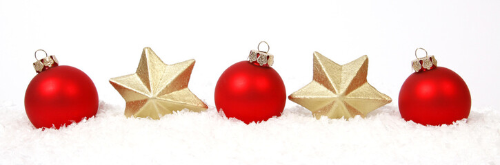 Red-golden baubles and golden star on the snow