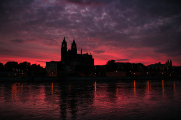 Cathedral of Magdeburg and the river Elbe at sundown