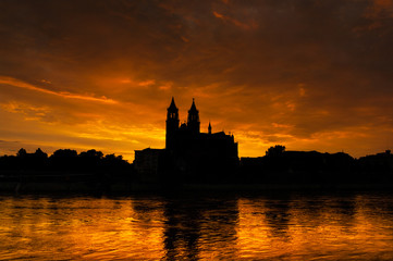 Cathedral of Magdeburg and the river Elbe at sundown