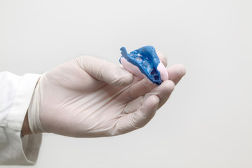 Dental, dentist holding  wax model of tooth at hand