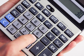 Fototapeta na wymiar Hand with calculator.