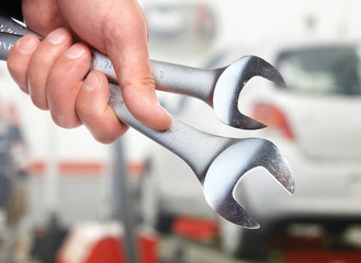 Hand with wrench. Auto mechanic.