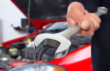 Hand with wrench. Auto mechanic.