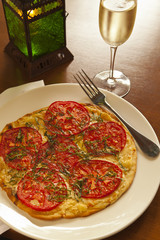margherita flatbread topped with tomatoes