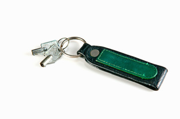 old key attached to a leather keychain