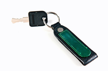 old key attached to a leather keychain