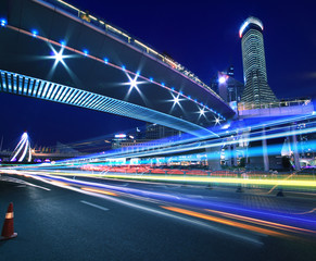 Fototapeta na wymiar Rainbow light highway at cityscape night in Shanghai