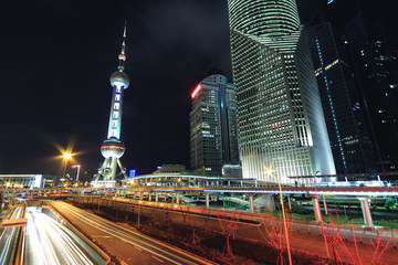Fototapeta na wymiar Night scene of Shanghai modern landmark buildings background car