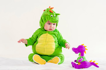 the small child in a green suit of a dragon