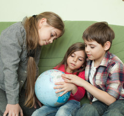 Kids looking at globe