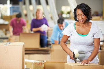 Workers In Warehouse Preparing Goods For Dispatch