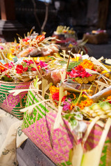 Offerings to gods in Bali with flowers, food and aroma sticks