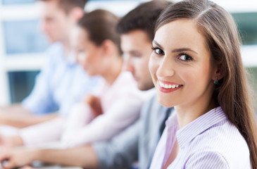 Businesswoman with coworkers in background