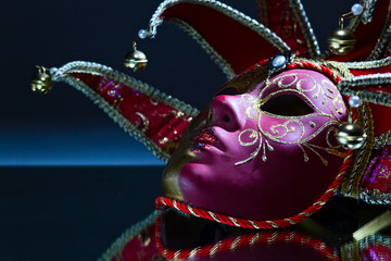 mask with bells on a mirror table