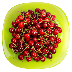 Obraz na płótnie Canvas Cherries fruits in a green glass bowl