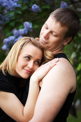 Fototapeta premium Happy young couple in a spring garden