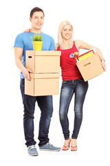 Fototapeta na wymiar Full length portrait of a young male and female holding boxes