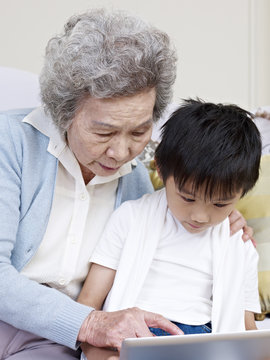 Grandma And Grandson Looking At Tablet Pc